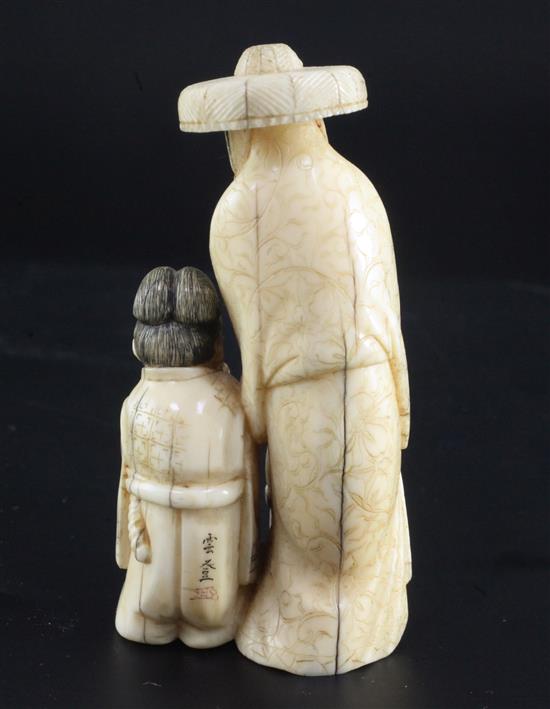 A Japanese walrus ivory okimono of a woman and three children, height 8.3cm